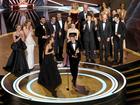 The cast and crew from Best Picture winner Anora celebrate on stage. 