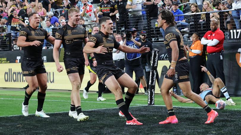 Daine Laurie celebrates with teammates after scoring the match-winning try.