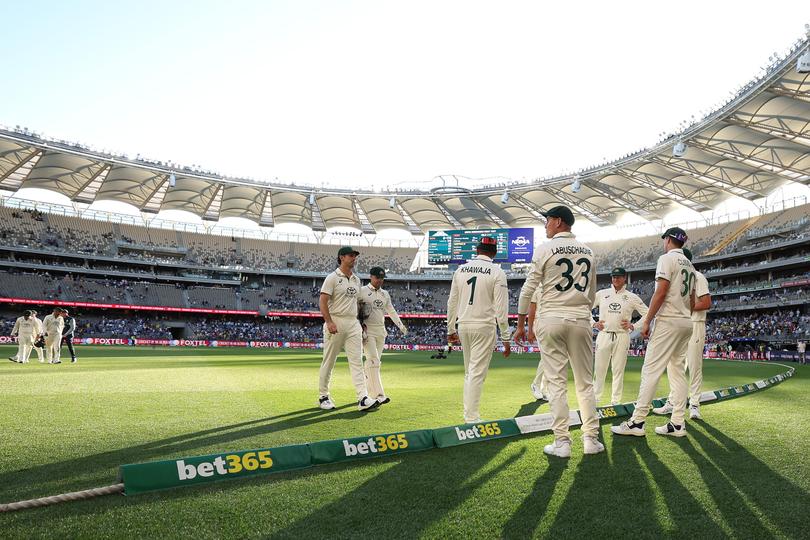 Australian players walk off the field over a bet365 gambling advertisement on the boundary rope. Inset, at the end of play on day two of the First Test match in the series between Australia and India at Perth Stadium on November 23, 2024 in Perth, Australia. (Photo by Robert Cianflone/Getty Images) Picture: Robert Cianflone