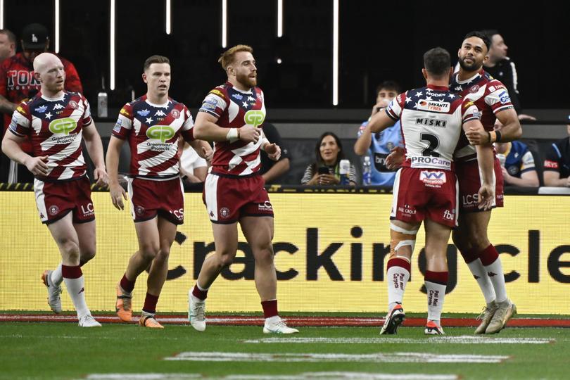 Bevan French, right, is congratulated by teammates after scoring a try.