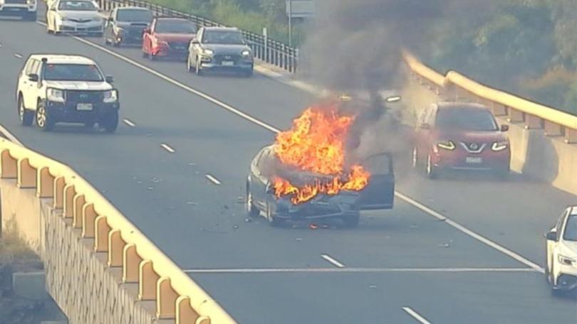 A car fire in the middle of a freeway in Melbourne’s southeast is causing traffic delays for morning commuters.