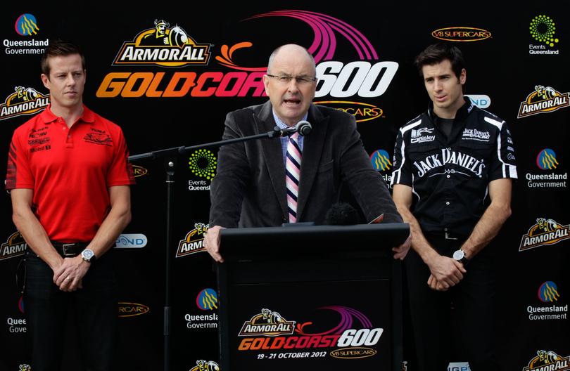 Then Supercars champion James Courtney, left, watches as then V8 Supercars chairman Tony Cochrane, right, launches the Gold Coast 600 in 2012.
