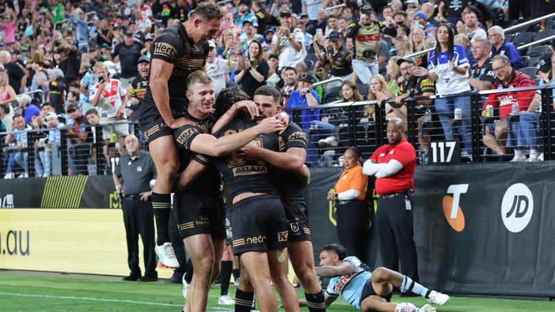 Daine Laurie celebrates  his match-winning try with his Panthers teammates. in Las Vegas.