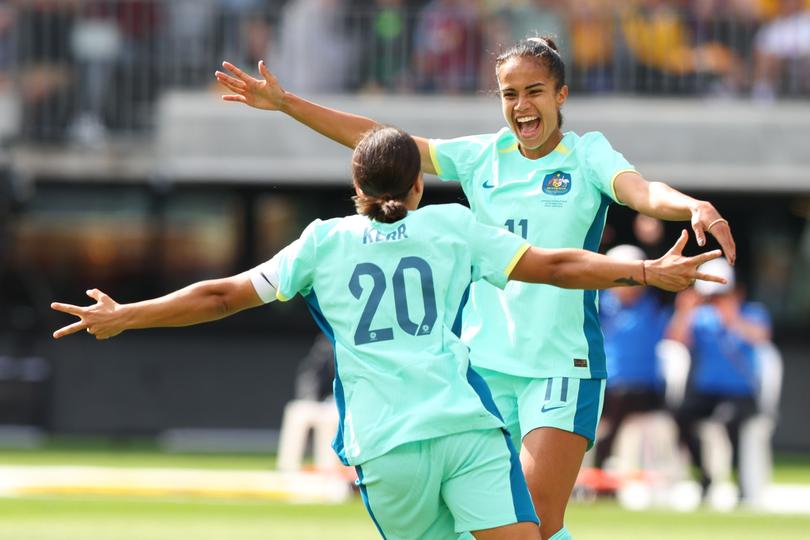 Mary Fowler and Sam Kerr of the Matildas celebrate a goal during an AFC Women's Asian Olympic Qualifier.