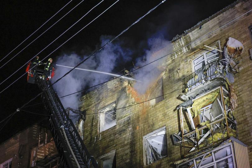 Ukrainian rescuers work at the site of a damaged building following a Russian drone attack on Sunday amid the ongoing Russian invasion in Kharkiv, Ukraine.