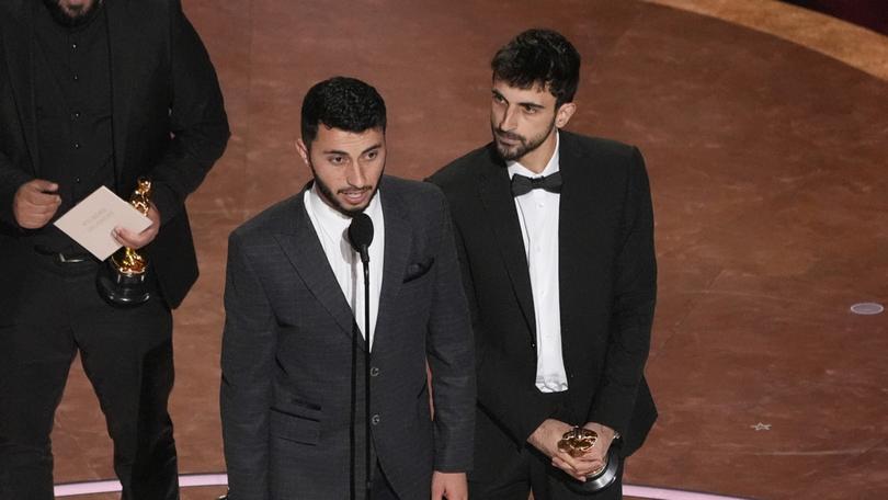 Rachel Szor, from left, Hamdan Ballal, Basel Adra, and Yuval Abraham accept the award for best documentary feature film for No Other Land during the Oscars in Los Angeles.