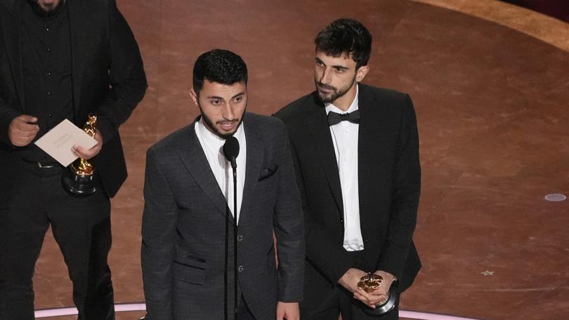 Rachel Szor, from left, Hamdan Ballal, Basel Adra, and Yuval Abraham accept the award for best documentary feature film for No Other Land during the Oscars in Los Angeles. 