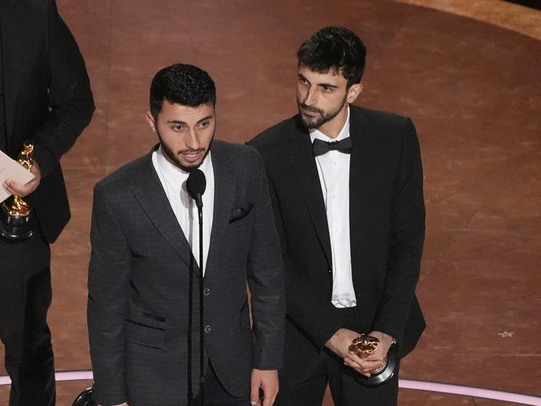 Rachel Szor, from left, Hamdan Ballal, Basel Adra, and Yuval Abraham accept the award for best documentary feature film for No Other Land during the Oscars in Los Angeles. 