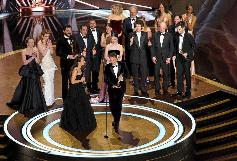 Sean Baker with his Anora cast and crew accepting the Oscar for best picture. 