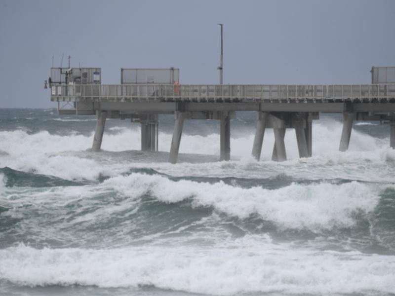 Strong winds and big waves are already starting to hit the Queensland coast ahead of Cyclone Alfred.