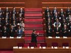 Chinese President Xi Jinping, centre, waves to senior members of the government as he arrives to the opening session of the National People's Congress.