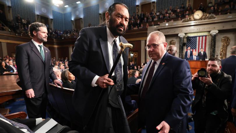 Democrat Al Green is removed from the chamber.