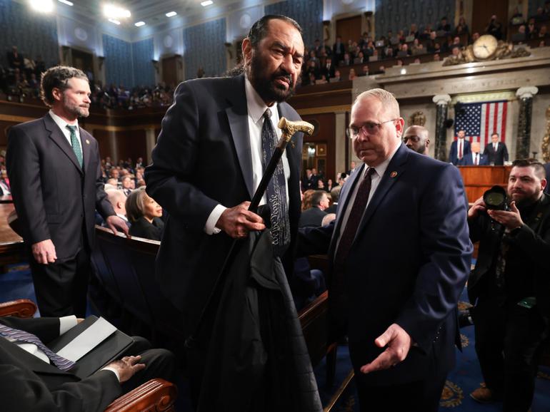 Democrat Al Green is removed from the chamber.