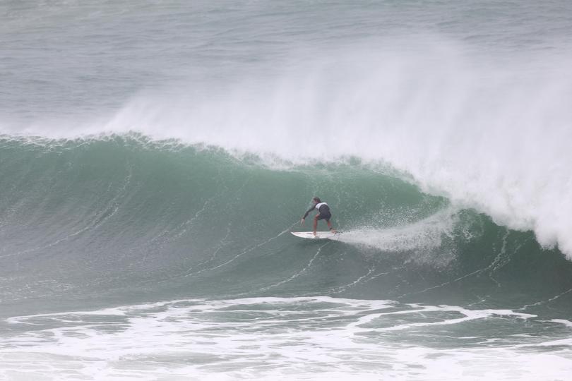 A surfer rides a wave at Kirra Beach on March 05, 2025 in Gold Coast, Australia. Tropical Cyclone Alfred is expected to make landfall in southeast Queensland as a Category 2 storm, marking the first time a cyclone has directly hit the region in over 50 years. 