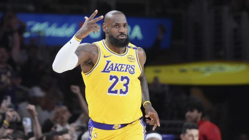 Lakers forward LeBron James gestures to the crowd after breaking the 50,000-points mark. (AP PHOTO)