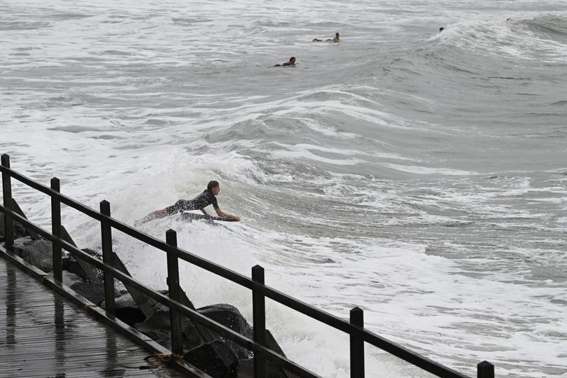 A young boy jumps into the surf ahead of cyclonic weather conditions on March 06, 2025 in Lennox Head, Australia. 