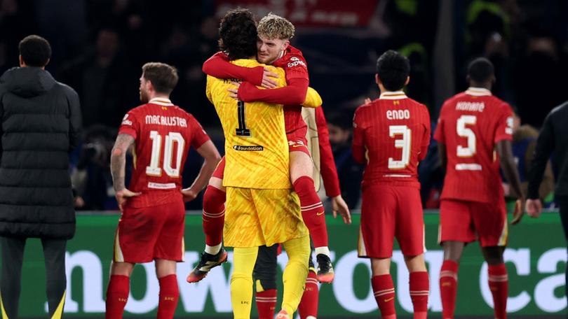 Harvey Elliott of Liverpool celebrates with teammate Alisson Becker.