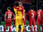 Harvey Elliott of Liverpool celebrates with teammate Alisson Becker.