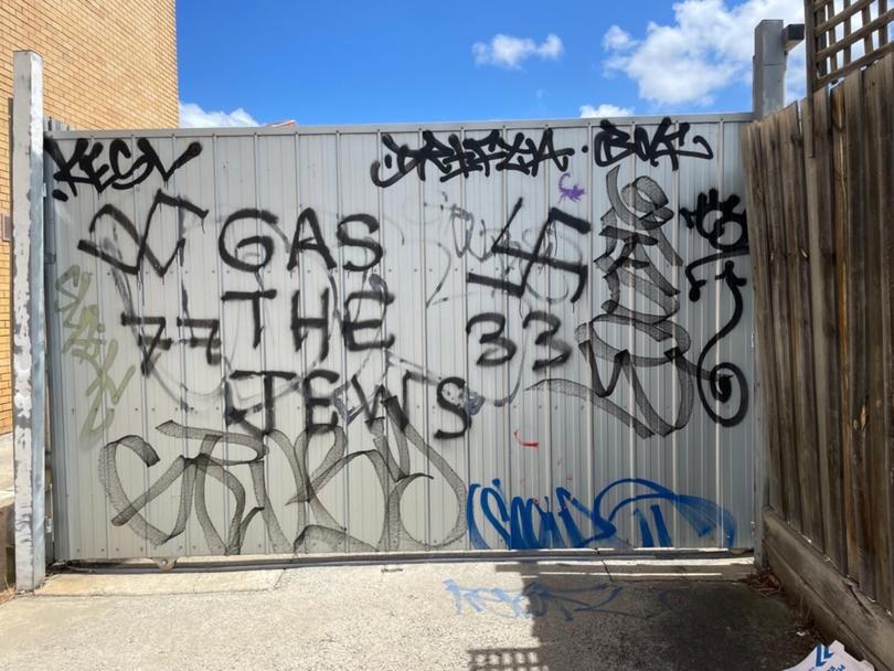 Anti-Semitic graffiti discovered on the wall of a recently closed-down Jewish-run business.