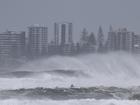 A person riding a jet ski attempts to tow surfboard riders amid record-breaking waves as the outer fringe of Tropical Cyclone Alfred started whipping eastern Australia, in Coolangatta.