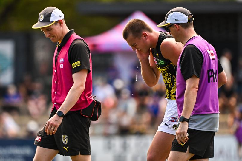 Sam Lalor walks off after fracturing his jaw.