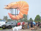 People fill up DIY sandbags beside the Big Prawn ahead of cyclonic conditions in Ballina, NSW.