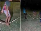 The youths were filmed laughing and jumping over the black-headed python on Wednesday night.