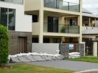  Sandbags are seen on a driveway at a home in the suburb of Nudgee Beach in Brisbane, Australia. 