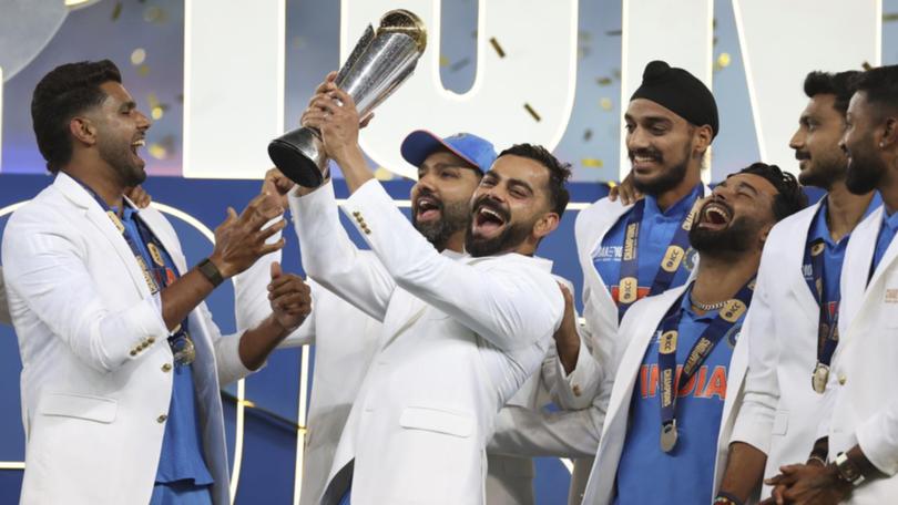 India's Virat Kohli and teammates savour the Champions Trophy after the win over New Zealand.