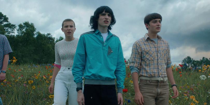 STRANGER THINGS. (L to R) Millie Bobby Brown as Eleven, Finn Wolfhard as Mike Wheeler and Noah Schnapp as Will Byers in STRANGER THINGS. Cr. Courtesy of Netflix  2022~|~|nCgQxQf2aL