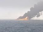 This image provided by Bartek Śmiałek shows smoke billowing from a vessel after a cargo ship hit a tanker carrying jet fuel off eastern England on Monday, March 10, 2025 setting both ablaze and sending fuel pouring into the North Sea. (Bartek Śmiałek via AP)