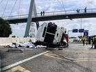 Some passengers were thrown out of a bus when it overturned in Johannesburg, officials say. (AP PHOTO)