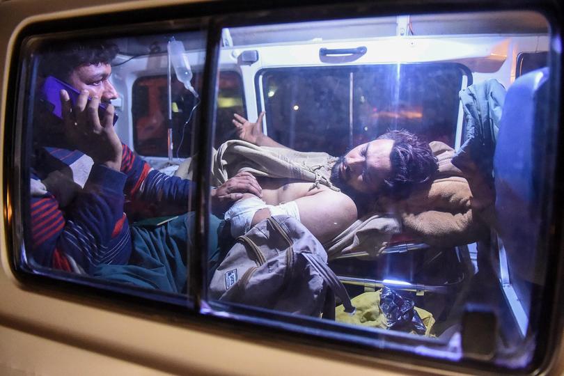 An injured train passenger is being transported following an operation against armed militants who ambushed the train in the remote mountainous area in Mach, southwestern Balochistan province on March 12, 2025.