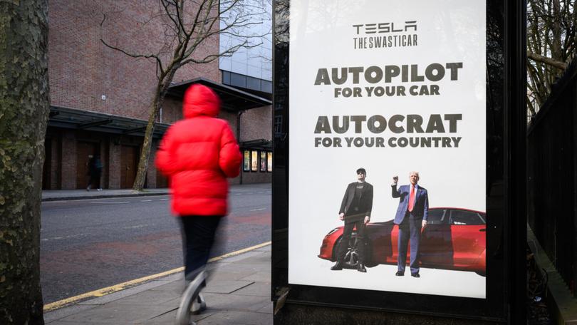 The latest in a series of posters critical of billionaire Elon Musk is displayed on a bus shelter in London. 