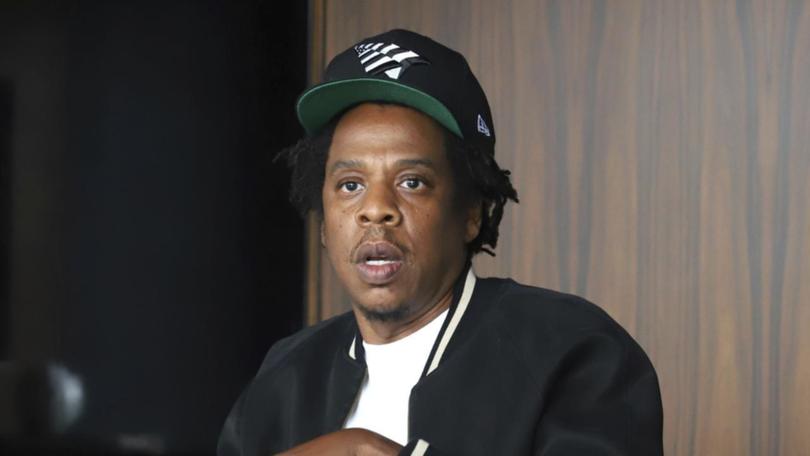 A woman who accused Jay-Z of teen rape apparently now says he was there but did not take part. (AP PHOTO)