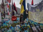 From left, Oksana Harei, 26, and Karina Harei, 25, look for a place to put flags near the relevant brigade at a makeshift memorial in Kyiv for soldiers killed since the start of Russia’s full-scale invasion of Ukraine in 2022. 