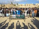 Residents offer funeral prayers for a railwayman killed by armed militants who ambushed a train in the remote mountainous area of Balochistan province, in Quetta. The bodies of at least 25 people, including 21 hostages, killed in a train siege by separatist gunmen in Pakistan were retrieved from the site on March 13 ahead of the first funerals.