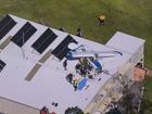 A man is trapped inside a light plane that has crashed into a building in Appin on Friday.