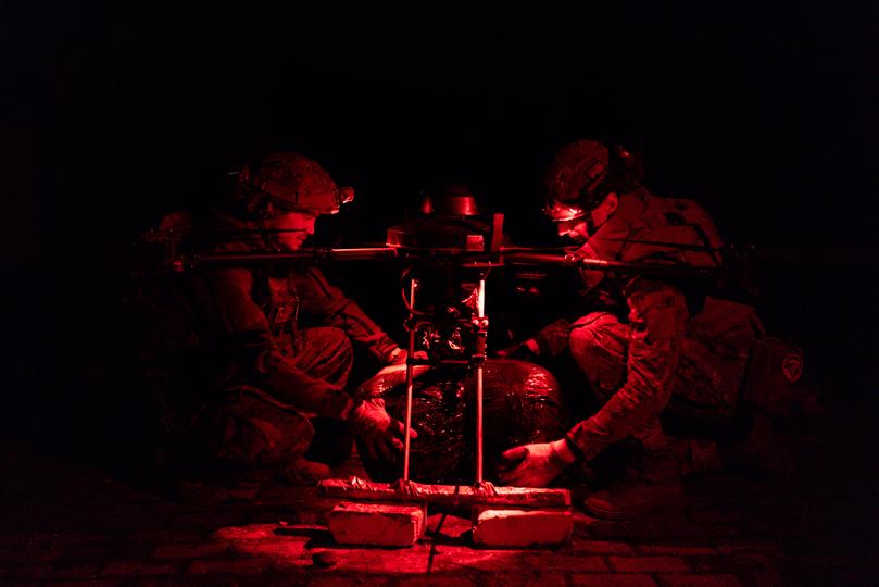 Members of Ukraine's 13th Brigade Khartiia load a Vampire drone with food and ammunition supplies to be delivered to the infantry at the frontline in Kharkiv.