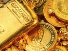 Gold bullion and Australian coins - stock photo by via Getty Images