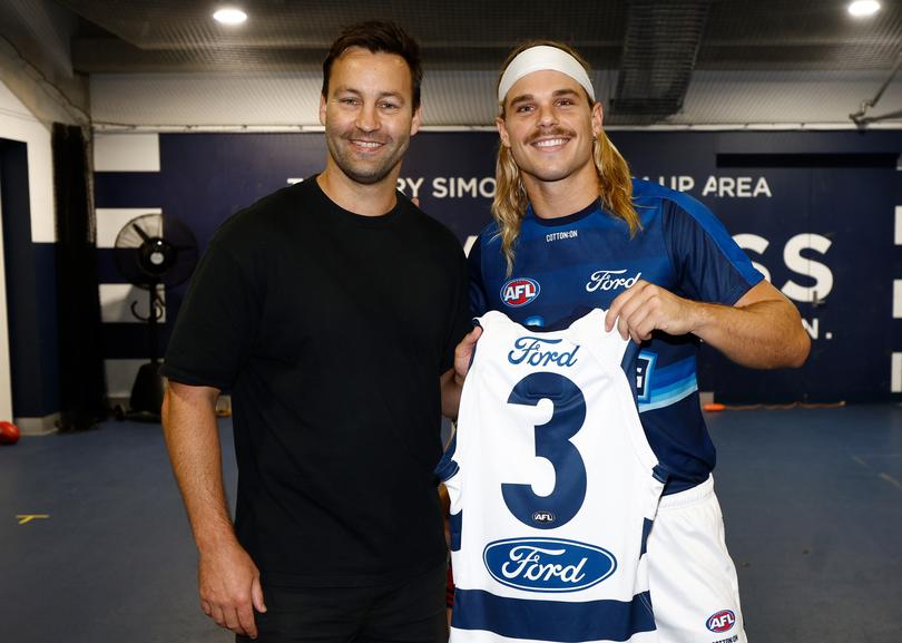 GEELONG, AUSTRALIA - MARCH 15: Jimmy Bartel presents Bailey Smith of the Cats with his jumper during the 2025 AFL Round 01 match between the Geelong Cats and the Fremantle Dockers at GMHBA Stadium on March 15, 2025 in Geelong, Australia. (Photo by Michael Willson/AFL Photos)