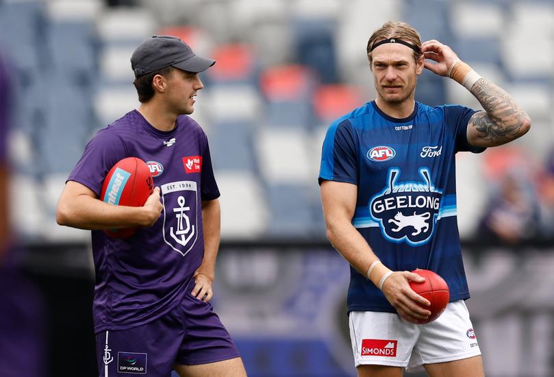 GEELONG, AUSTRALIA - MARCH 15: (L-R) Jordan Clark of the Dockers chats with former teammates Tom Stewart of the Cats (right) during the 2025 AFL Round 01 match between the Geelong Cats and the Fremantle Dockers at GMHBA Stadium on March 15, 2025 in Geelong, Australia. (Photo by Michael Willson/AFL Photos)