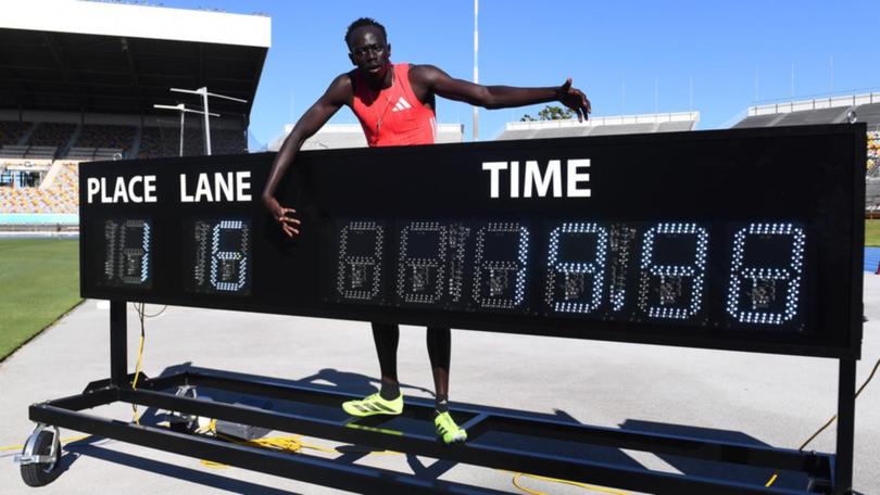 Gout Gout celebrates breaking the 20-second barrier for the first time. (Jono Searle/AAP PHOTOS)