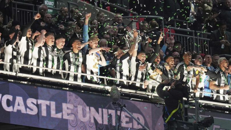 Newcastle United lift aloft the League Cup, their first major domestic trophy for 70 years.