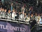 Newcastle United lift aloft the League Cup, their first major domestic trophy for 70 years.