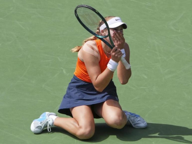 Mirra Andreeva sinks to her knees after claiming the singles title at Indian Wells.