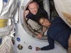 Butch Wilmore and Suni Williams pose for a portrait inside the vestibule between the forward port on the International Space Station's Harmony module and Boeing's Starliner spacecraft on June 13, 2024.