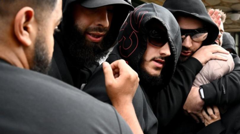 Sarah Abu Lebdeh (centre, pale scarf) was surrounded by supporters as she left court. (Bianca De Marchi/AAP PHOTOS)