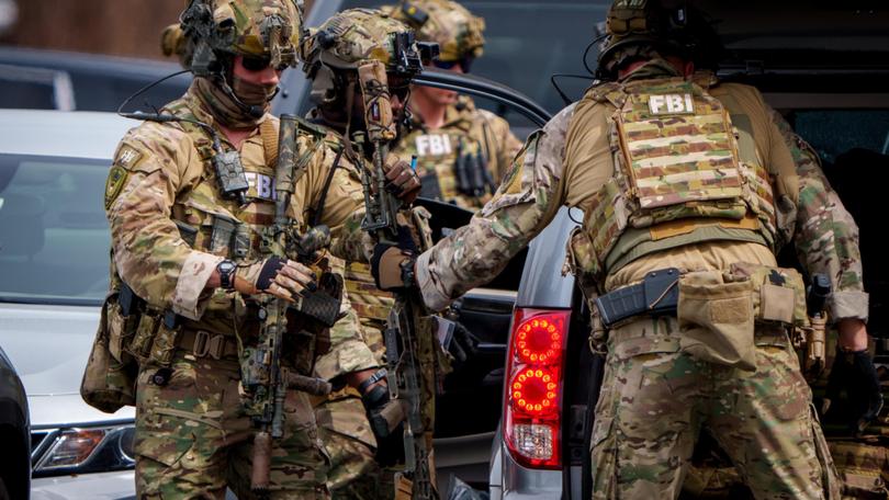 Members of FBI SWAT arrive as law enforcement responds to reports of an armed individual near CIA headquarters.