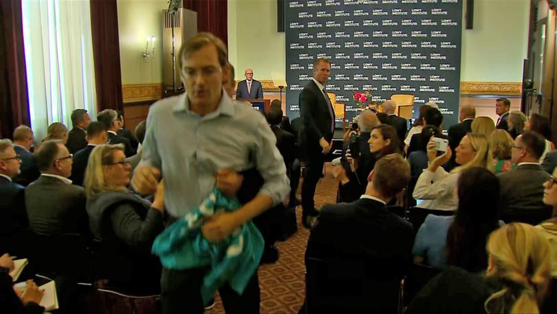 A person is removed by security during the Opposition Leader Peter Dutton’s address to the Lowy Institute in Sydney, Thursday, March 20, 2025. 